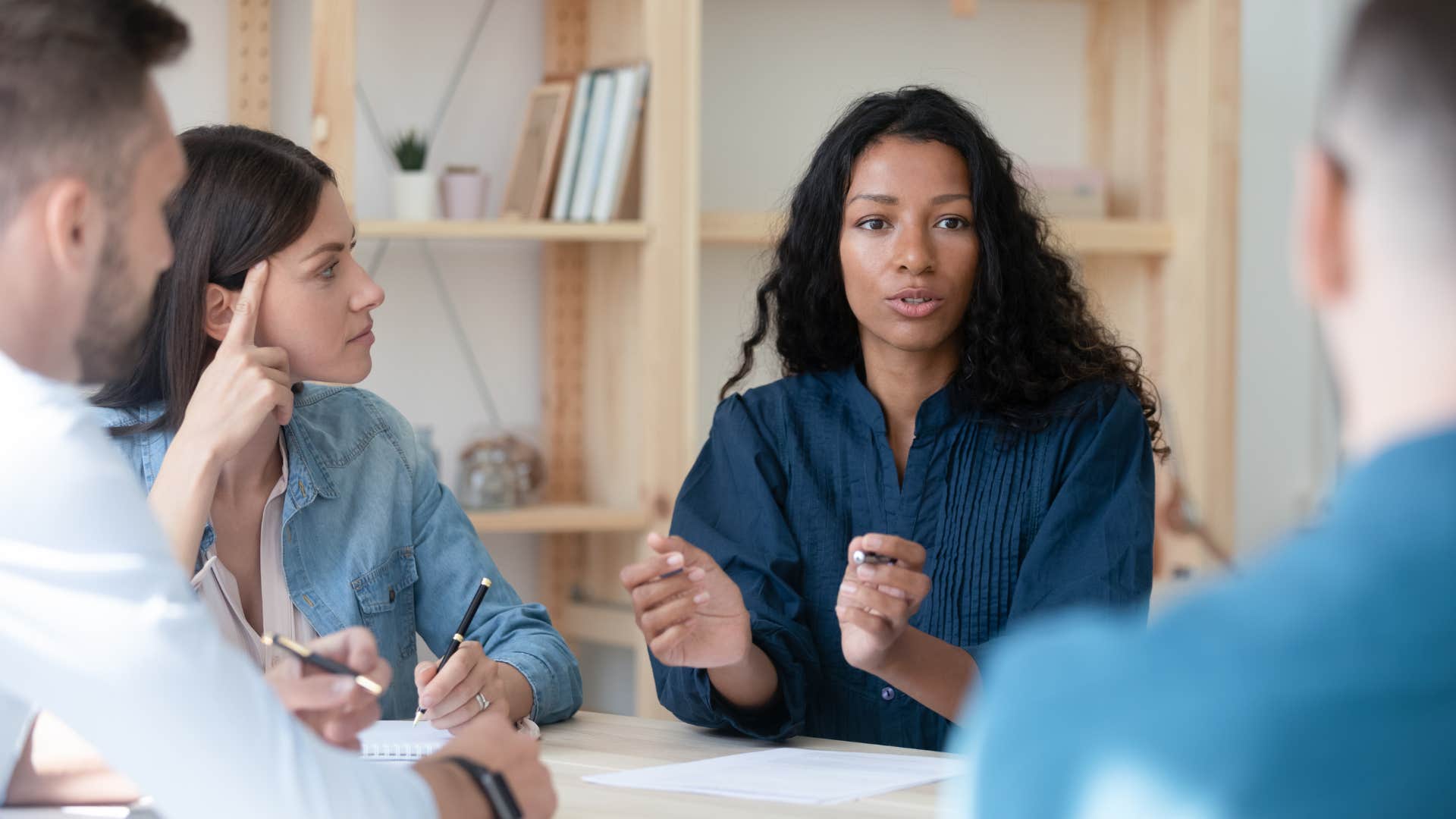 Woman talking in a meeting of coworkers 